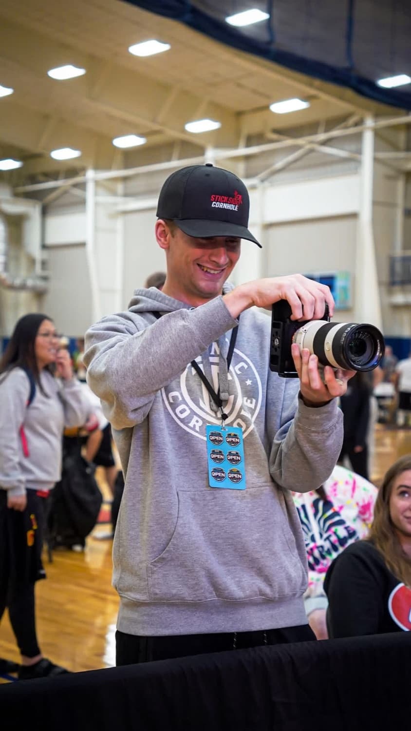 Zack filming content at a cornhole event